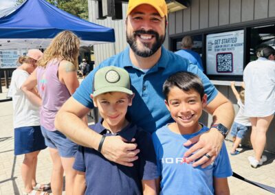 Smiling dad with two boys outside the Bogus Basin guest services building