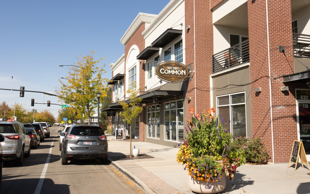 Eight Thirty Common restaurant on a sunny street in Downtown Meridian, Idaho, with flower planters along the sidewalk