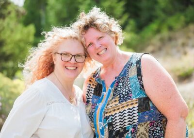 Two smiling women posing together outdoors at Bogus Basin